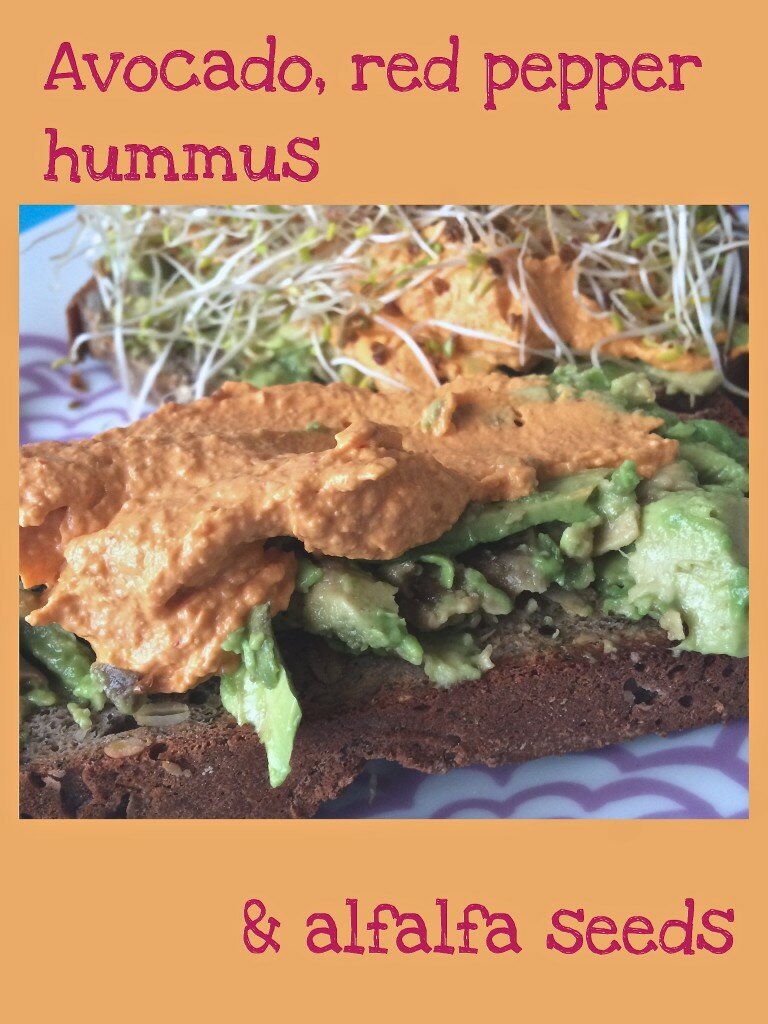 Gluten free buckwheat and coconut bread with avocado, red pepper hummus and alfalfa